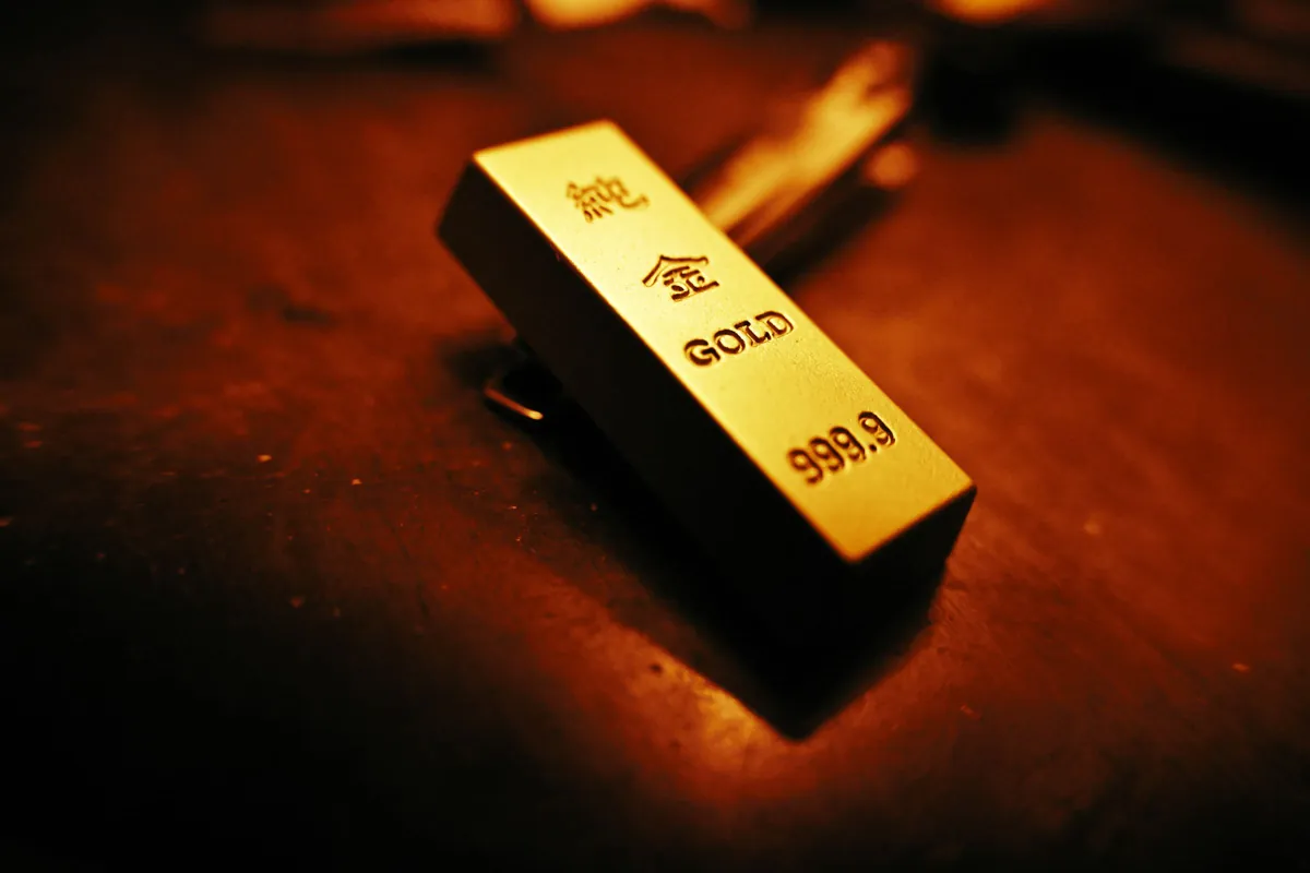Small gold bar stamped 999.9 in warm low light